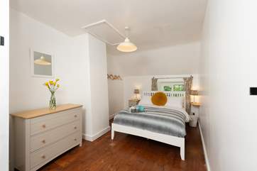 The double bedroom is bright and spacious, with dual-aspect windows.
