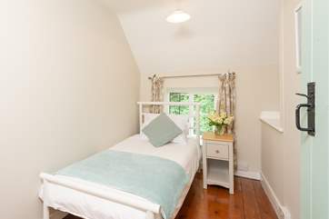 The pretty single bedroom looks out over the front of the cottage.