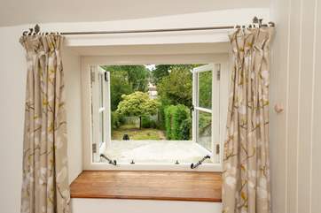 A lovely view from the landing window looking over the garden. We love the character of the wonky walls!