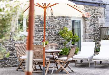 The outside patio area with its olive trees has a Mediterranean-style.