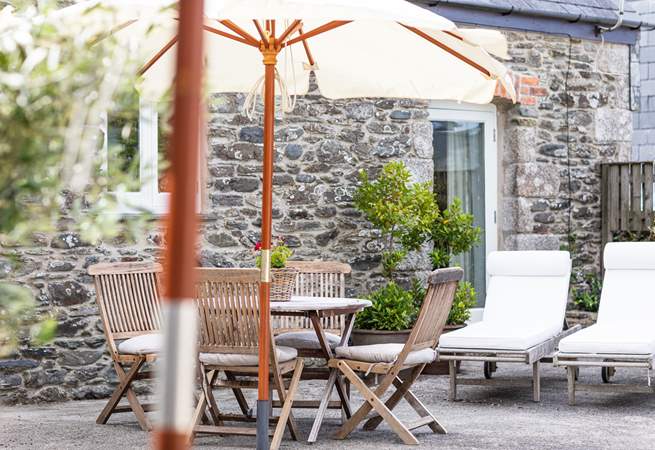 The outside patio area with its olive trees has a Mediterranean-style.