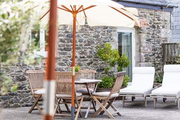 The outside patio area with its olive trees has a Mediterranean-style.