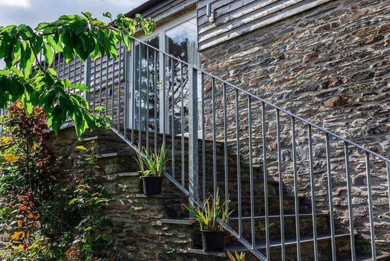 Local stone and slate steps lead up to the living-room.
