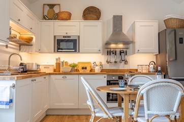 The sociable kitchen has a dining-table for four.