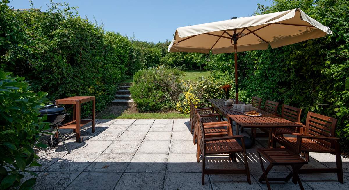 Step out of the house onto this fabulous patio and large garden which stretches out beyond.