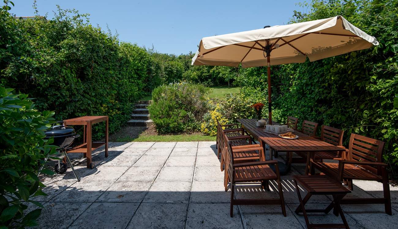 Step out of the house onto this fabulous patio and large garden which stretches out beyond.