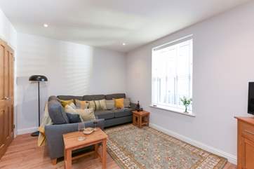 The open plan sitting-area, is light and airy.