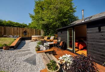 With sun loungers, outside furniture for dining al fresco and a bubbling hot tub.