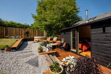 With sun loungers, outside furniture for dining al fresco and a bubbling hot tub.