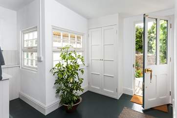 The utility-room opens to the sunny patio, this space is perfect for sandy flip-flops or a bucket and spade.