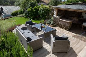 Such a beautiful garden and decked area, with a fabulous undercover area to store barbecue food or take shelter if required.