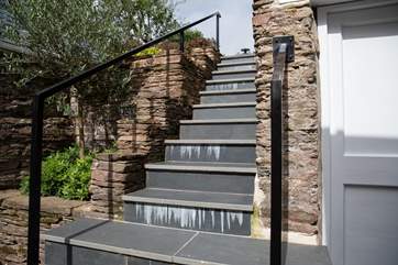 From the kitchen door, there are 21 steps up to the top patio.