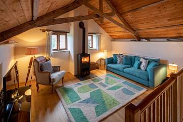Fabulous living area with a glowing wood-burning stove for those chillier evenings.