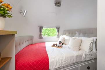The bedroom has a unique curved king-size bed.