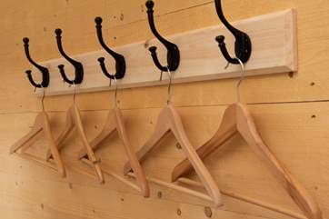 Hooks and hangers are on-hand for your clothes.
