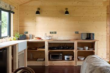 The kitchen is complete with a electric hob, mini oven, slow cooker and microwave.