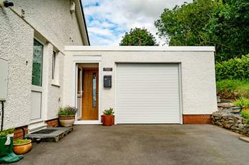 Viewtown Linhay hides at the back of the owners' bungalow. The entrance door and hallway runs along the side of the garage, you're not behind the garage door. This is your designated parking space.