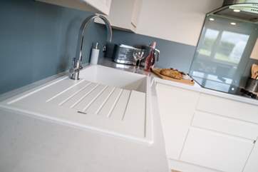 The kitchen is fully functional along with a washing machine.