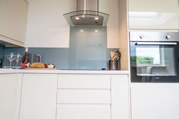 The kitchen also offers a microwave housed above the oven.