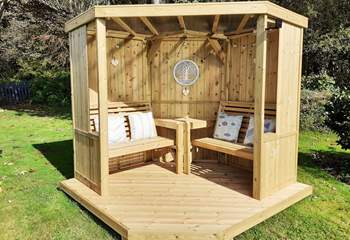 Sit out in the summer house in the garden while enjoying a drink and a good book.