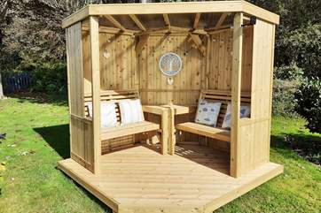 Sit out in the summer house in the garden while enjoying a drink and a good book.