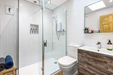 The bathroom has a walk in electric shower.