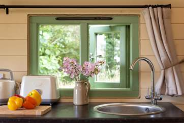 The kitchen-area has a pretty view into the woodland and is equipped with everything you will need. 2 ring hob, slow cooker, fridge, kettle, toaster and microwave.