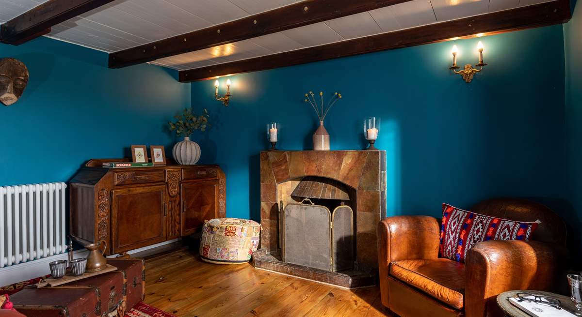 The snug has views out over the sea and another gorgeous ornamental fireplace. 