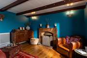 The snug has views out over the sea and another gorgeous ornamental fireplace.