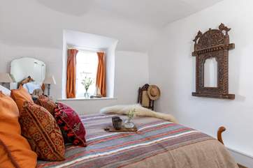 White washed walls and warm fabrics create a peaceful atmosphere.