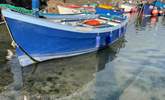 Pretty fishing boats rest in the harbour in Coverack.  - Thumbnail Image