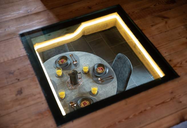 Need to keep an eye on the chef? No problem with this beautiful window looking down from the sitting-room in to the kitchen/diner.