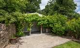 This Mediterranean-style, under cover seating-area is yours to enjoy. A perfect spot for pre-dinner drinks. - Thumbnail Image