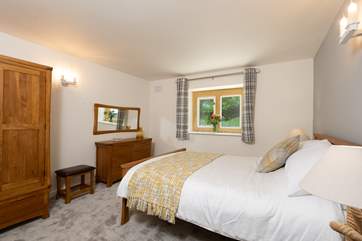 The master bedroom is full of light and looks out towards the garden.