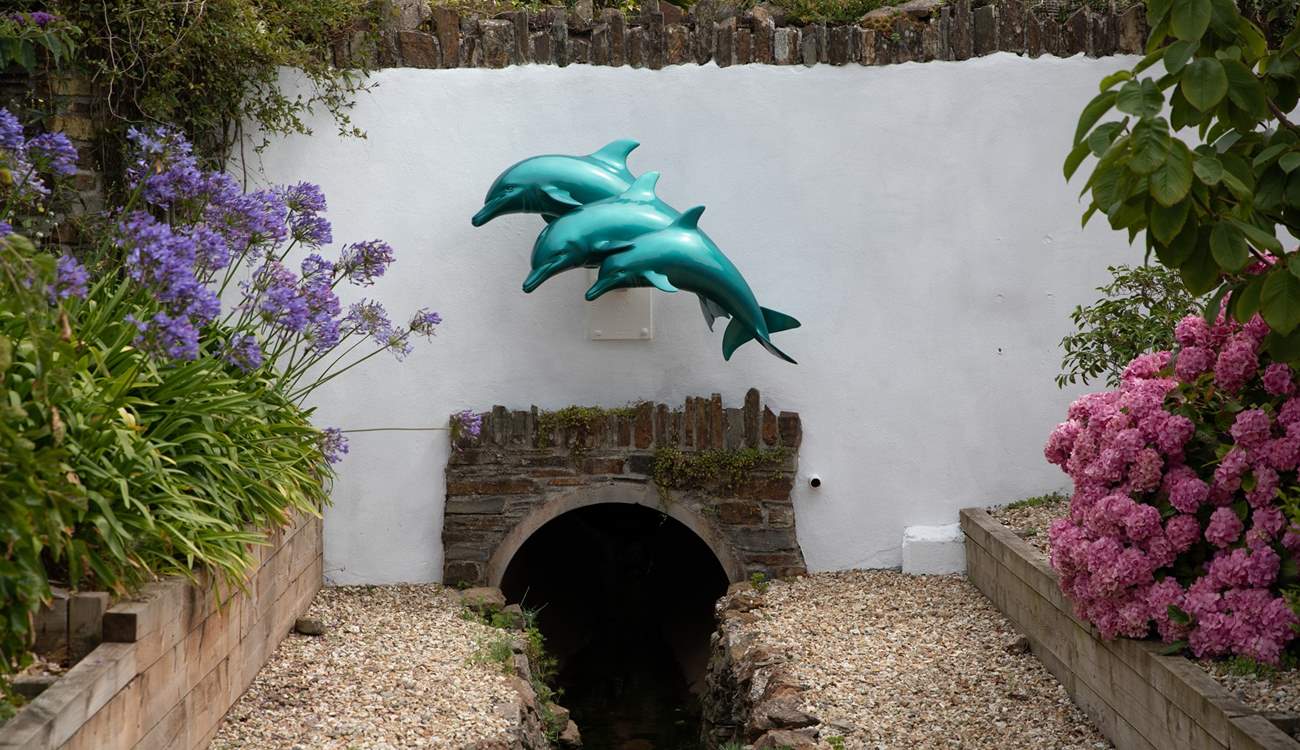 Just look for the dolphins and you know you're home. Please note, the stream running in front of the property is fully fenced off and secure.