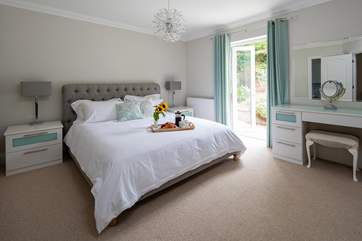 The master bedroom (bedroom 5) has access directly onto the rear patio area.