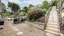 The rear patio area is a fully enclosed and a great place to let your four-legged friends off the leash. Steps up to the raised sun bathing patio area.

