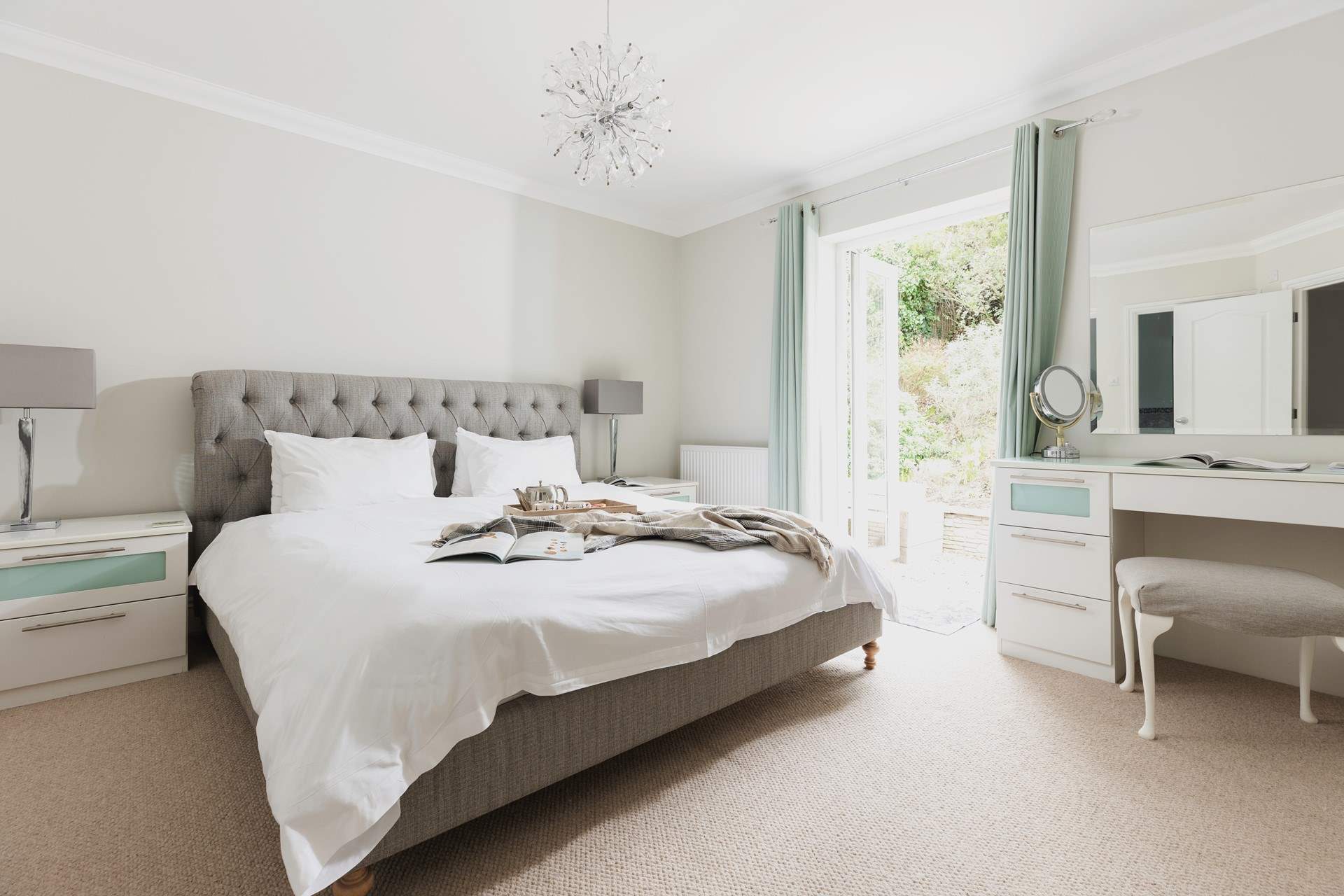 The master bedroom (bedroom 5) has access directly onto the rear patio area.