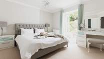 The master bedroom (bedroom 5) has access directly onto the rear patio area.