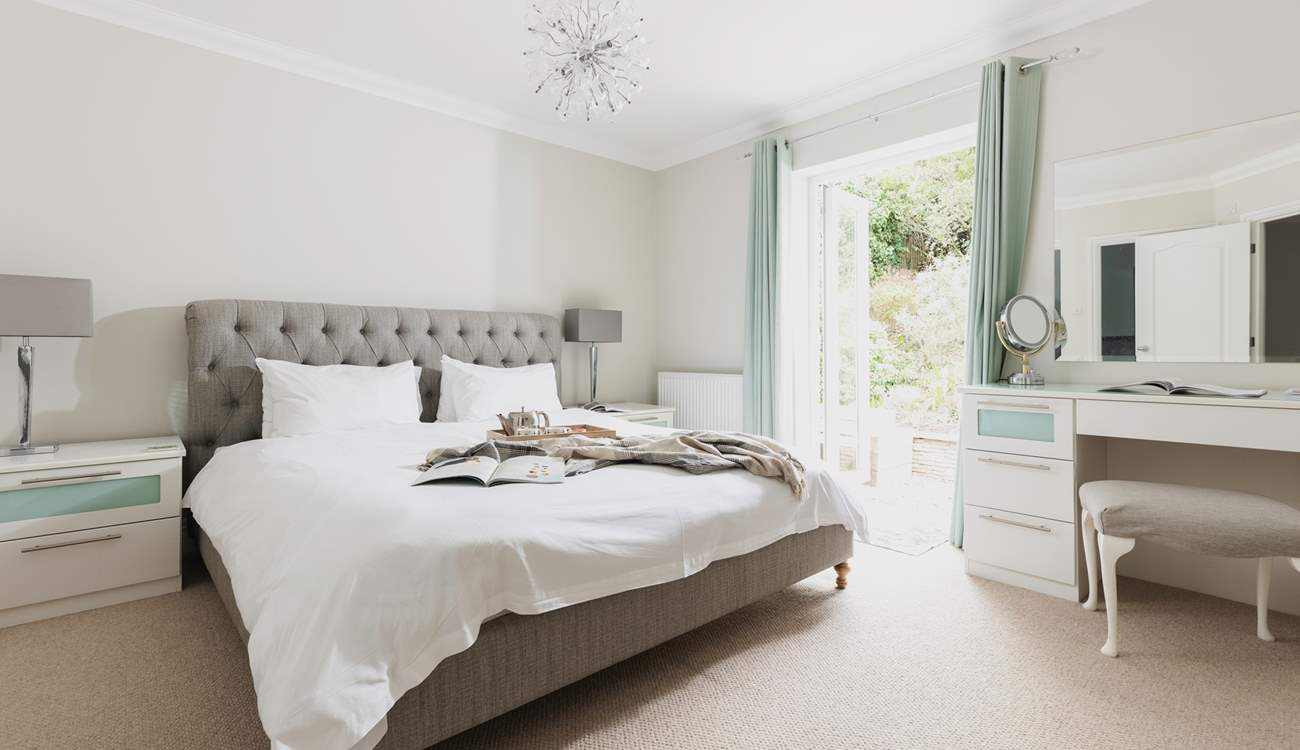 The master bedroom (bedroom 5) has access directly onto the rear patio area.