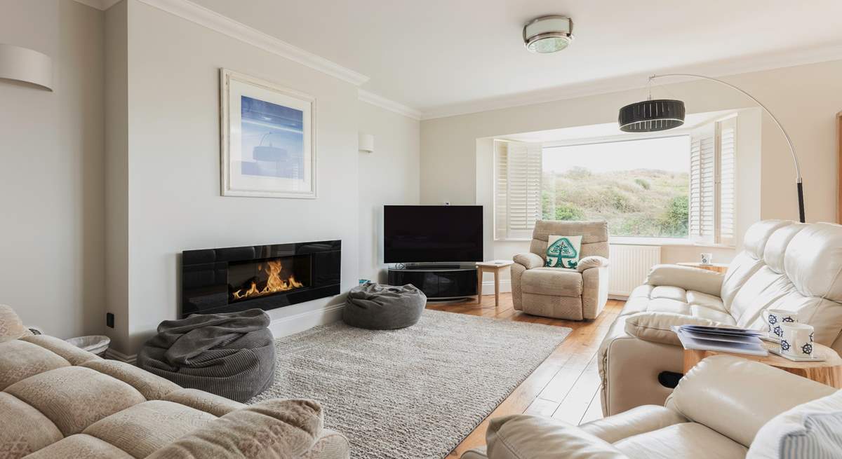 The spacious sitting-room opens out onto the balcony.