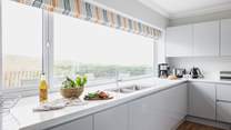 The kitchen fills with natural light. 