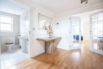 The entrance hall leads to the bathroom and the living and dining area.