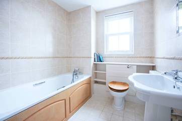 Enjoy a soak with a good book in the family bathroom.