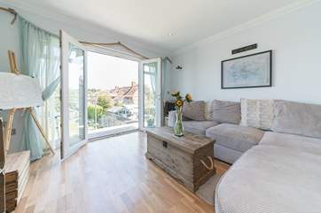 Light and airy, the open plan living-room with kitchen, dining area and balcony.