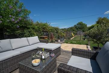Relax after a busy day with a glass of wine while watching the children play in the garden.