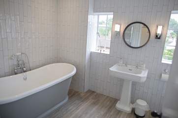 The main bathroom is large enough to accommodate both the roll-top bath, shower, WC and wash-basin.