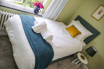 The twin room is dual-aspect so another light room with a view of the estuary and the garden to the back of the house.