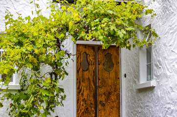 The front door of The Old Kiln is accessed via steps up from the main level of the garden.