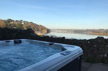 The wonderful hot tub sit on the front terrace overlooking the estuary.